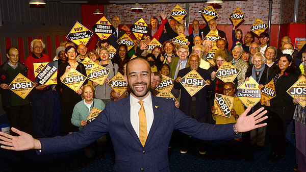 Image of Josh Babarinde MP with crowd of Lib Dem supporters 